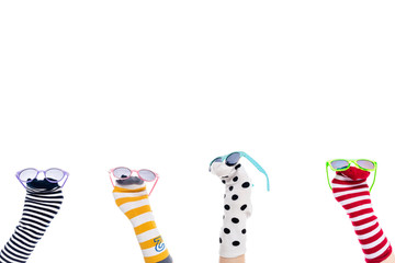 cropped view of people with colorful sock puppets and sunglasses on hands Isolated On White