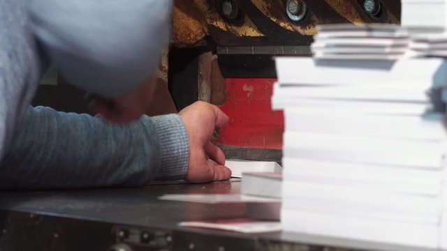 Typography Worker Cuts A String With Calendars On A Cutter