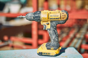 Power drill cordless tool for fast working on a construction site.
