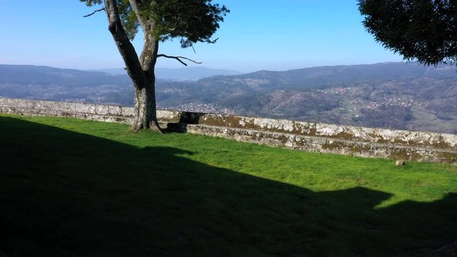 Aerial backwards reveal old hilltop Peneda chapel in Redondela, Spain