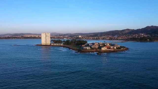 Aerial dolly backwards of beautiful sunset in Toralla private island in Vigo, Spain