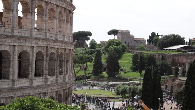Colosseum, Roman forum and palatine in Rome. Panoramic shots, the amphitheater in the foreground and archaeological excavations in the background.