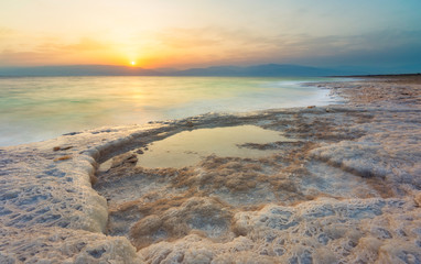 Dead Sea Sunrise with salt formations in the foreground