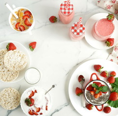 Top view tasty and healthy food for breakfast and snack with fresh strawberries. Yogurt with strawberries, smoothies, rice waffles, cornflakes, milk. copy space