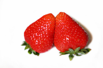 Two strawberries close up isolated on white background. Red ripe strawberry