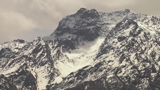 Extreme close-up low-angle still shot of Indian Himalayan ranges with glacier slowly flowing down their steep ar tes and ridges, Kargil-Ladakh