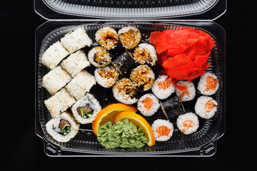 sushi rolls mix in a plastic box container