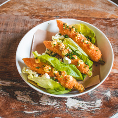 Delicious vegeterian tapas dish with fried carrots wrapped in lettuce
