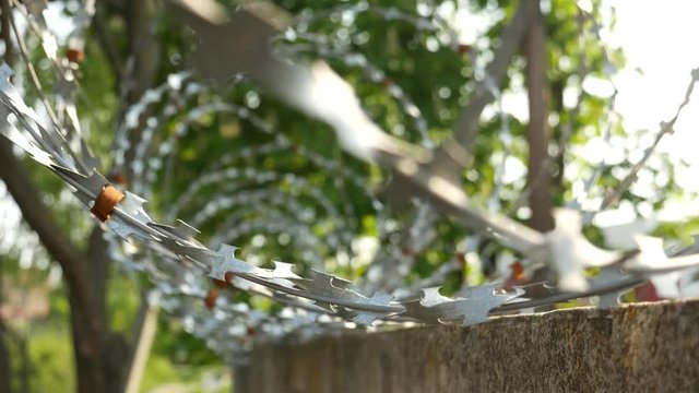 High Reinforced Concrete Wall with Barb Wire Fence