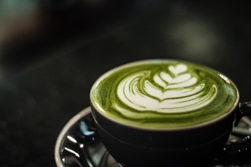 A cup of green tea matcha latte ,soft focus