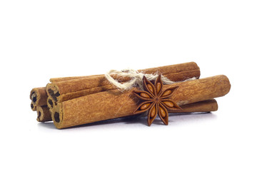 Cinnamon sticks and anise stars on white background.