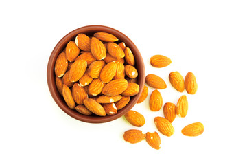 Top view of bowl full of almonds and isolated on a white background