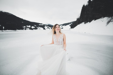 Beauty woman, bride with perfect white dress background mountains