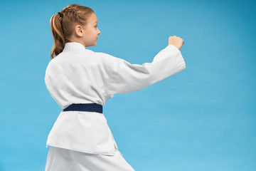 View from back of girl doing karate on isolated background