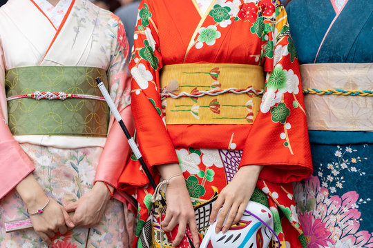 Young girl wearing Japanese kimono standing in front of Sensoji Temple in Tokyo, Japan. Kimono is a Japanese traditional garment. The word "kimono", which actually means a "thing to wear"