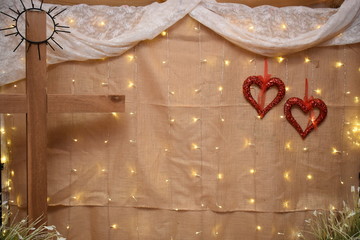 Wooden cross and red hearts backdrop