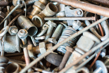 Close-up old used spare part, rust bolts and knots many sizes