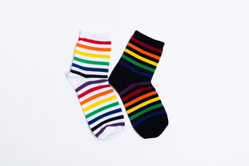 Two negative socks with striped pattern on white background. Clothes for feet with black and white textile. Copy space