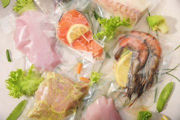 Sous Vide cooking concept. Vacuum packed ingredients arranged on light background.