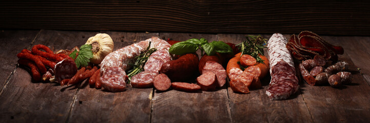 cold meat assortment with delicious salami and  fresh herbs . Variety of meat products including coppa and sausages