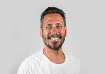 Obraz premium portrait of young happy and attractive man with blue eyes and beard looking cool smiling happy and confident wearing white t-shirt isolated on studio background