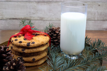 A glass of milk and cookies for Santa. Christmas Eve Concept.