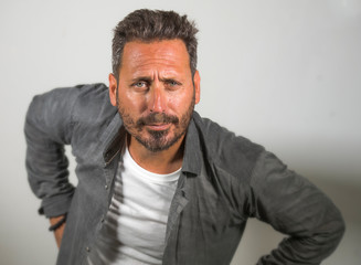 Obraz premium young happy and handsome 40s man with blue eyes and beard in casual shirt posing in cool attitude smiling cheerful and confident on studio background