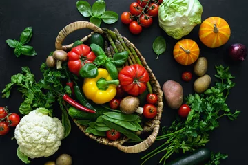 Fotobehang Fresh vegetables on a dark kitchen surface © fortyforks