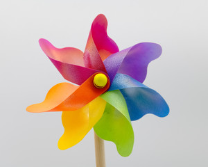 A stationary multi-coloured  toy windmill.