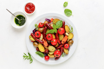 Sausages roasted with vegetables, view from above
