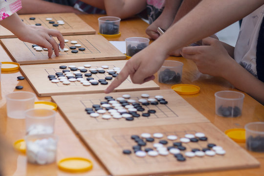 People participate in the go game.  Alphago