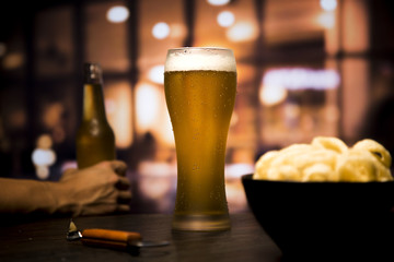 Beer glass in front of blurred background
