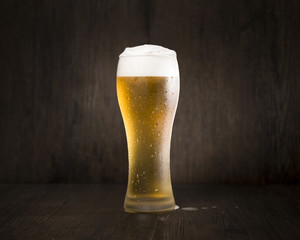 Beer glass in front of black background