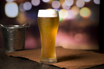 Beer glass in front of blurred background