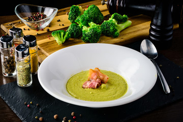 Broccoli cream soup with bread on a table. Classic European food