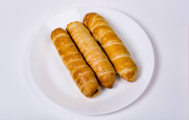 sausage dough on a white plate, the background is white
