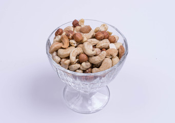 A mixture of cashew nuts, almonds, hazelnuts in a wine glass