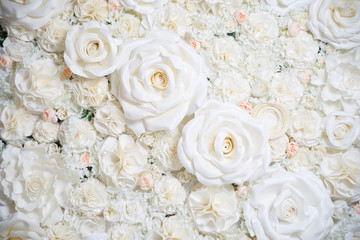 Obraz na płótnie Canvas Delicate wedding floral wallpaper made of artificial beige roses.