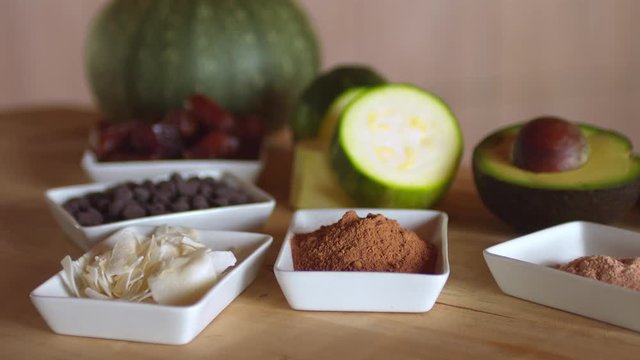 Ingredients to prepare a raw vegan dessert, presented on a wooden table