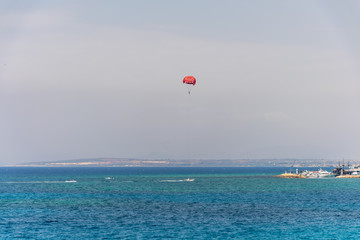CYPRUS, AYIA NAPA - MAY 11/2018: tourists have fun on a parachute over the Mediterranean Sea near the seaport.