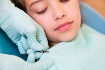 Closeup of girl at the dentist preparing for the treatment
