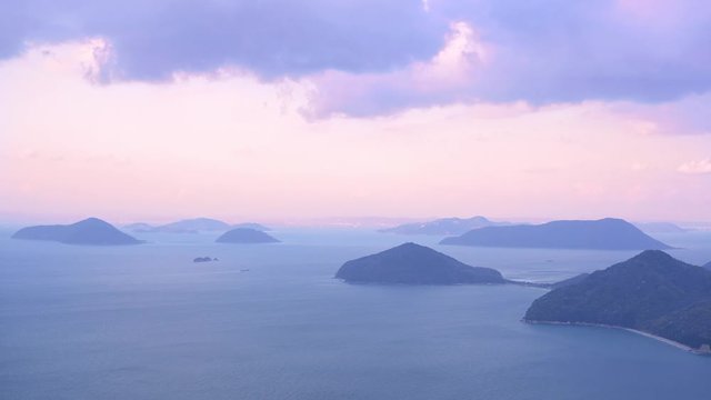 Footage the direction of Seto Ohashi from the summit of the Shimoide mountain in Mitoyo city, Kagawa Prefecture, and the sea and islands of the Seto Inland Sea at dusk.