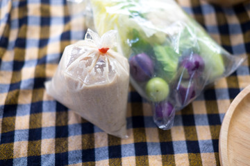 Pickled fish with minced pork in coconut milk and fresh vegetables in plastic bag