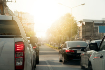 Cars parked on traffic signs on the intersection and turn on the brake lights. Traveling to travel in the city. Hope and purpose that lies ahead with light.
