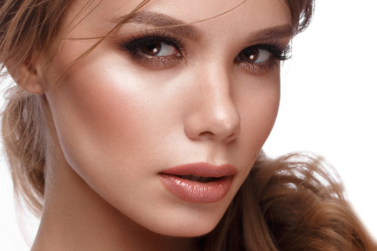 Pretty girl with easy hairstyle, classic makeup, nude lips Beauty face.