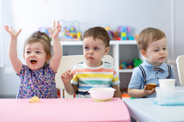 Group of children have a lunch in daycare centre. Kids eating in kindergarten