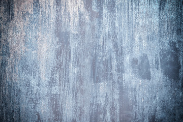Abstract background with place for text. Old metal fence unevenly painted with dirty blue paint. Unusual pattern with vignette.