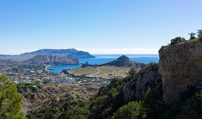 Fototapeta na wymiar View of the resort town of Sudak and the medieval Genoese fortress from a mountain slope.