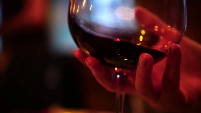 Shaking large glass of red wine for an oxygenation