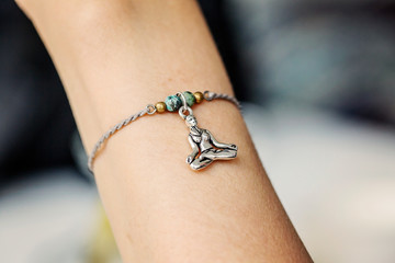 Female wrist wearing tiny jewelry bracelet with mineral stone beads